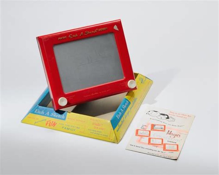 Toy that was originally called “L’Écran Magique” (“The Magic Screen”) Crossword Clue